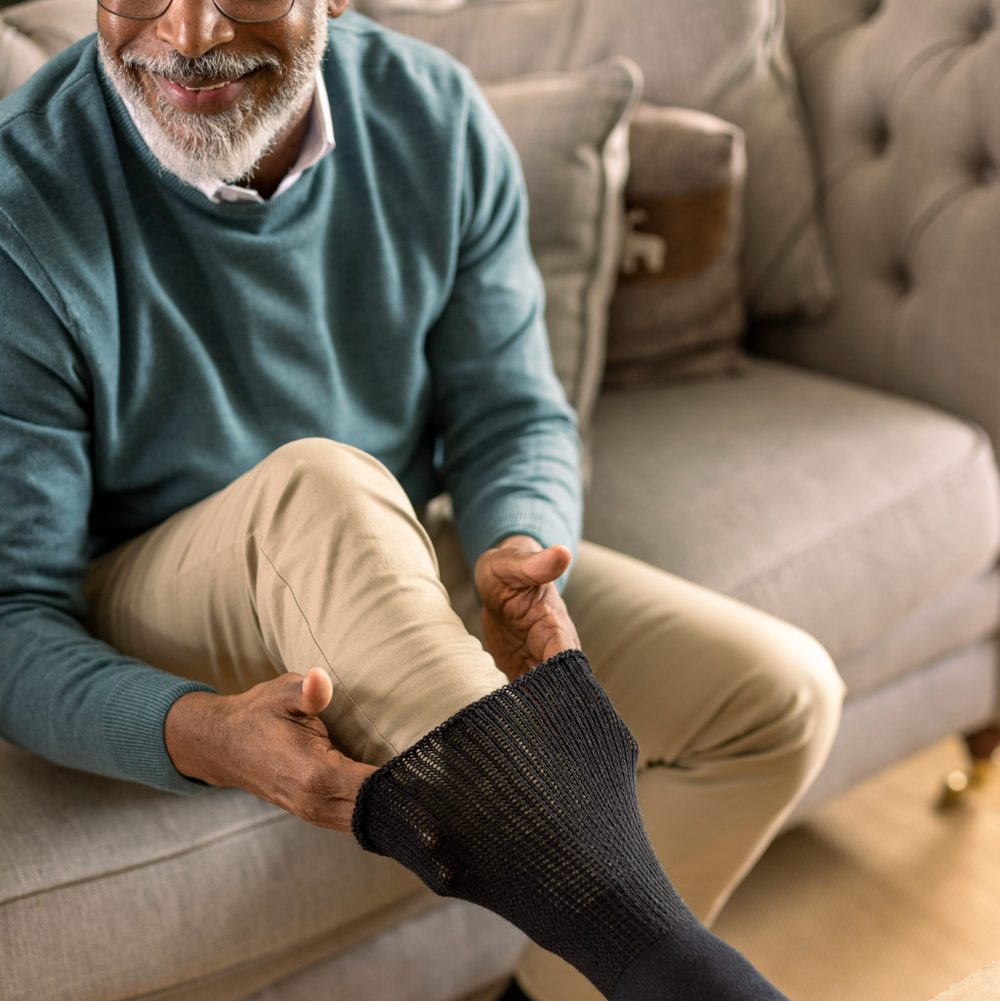 Man putting on comfortable non-binding socks